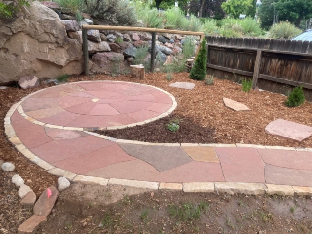Custom designed spiral flagstone patio with flagstone walkway with stone borders