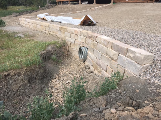 Traditional dry stone retaining wall used to retain driveway.